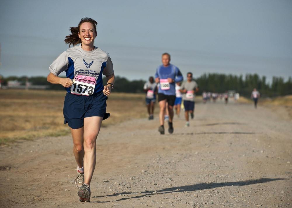 runners jogging in an outdoor setting on a gravel road