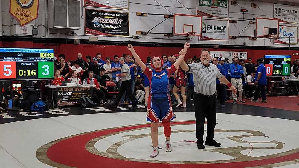 DHS Girl's wrestler Reanna raising hands in victory
